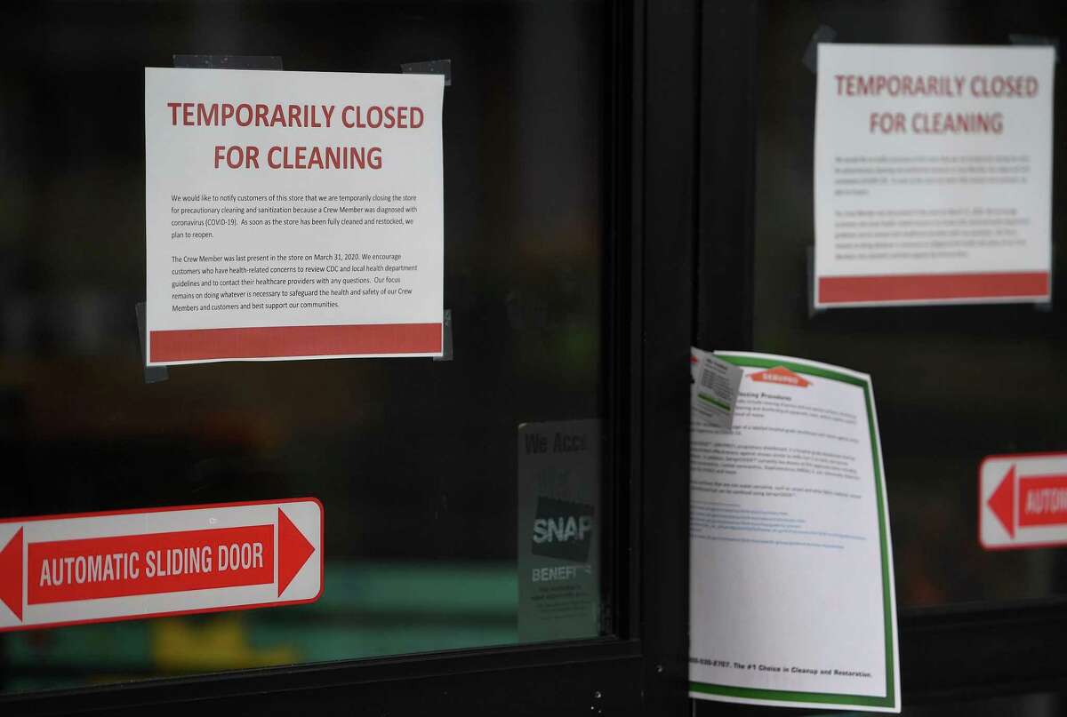 Signs inform customers at the Trader Joe's store at 2258 Black Rock Turnpike closed for cleaning after an associate tested positive for Covid-19 in Fairfield, Conn. on Thursday, April 2, 2020.