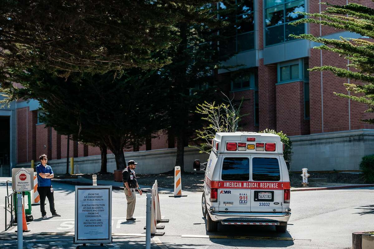 Security guards watch as an ambulance enters the San Francisco Campus for Jewish Living in San Francisco, Calif. on Thursday April 2, 2020.