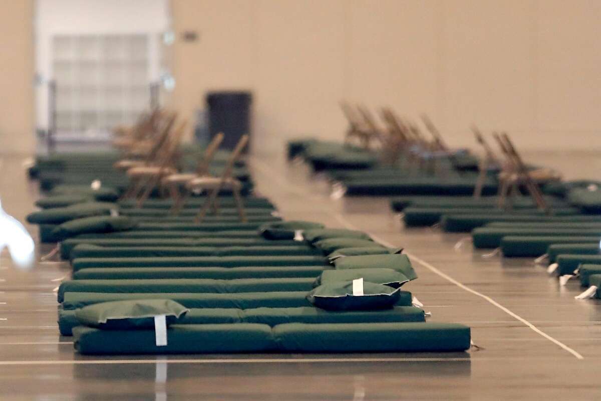 Cots are spread out on the floor as Moscone West is readied to become a shelter during coronavirus shelter in place in San Francisco, Calif., on Thursday, April 2, 2020.