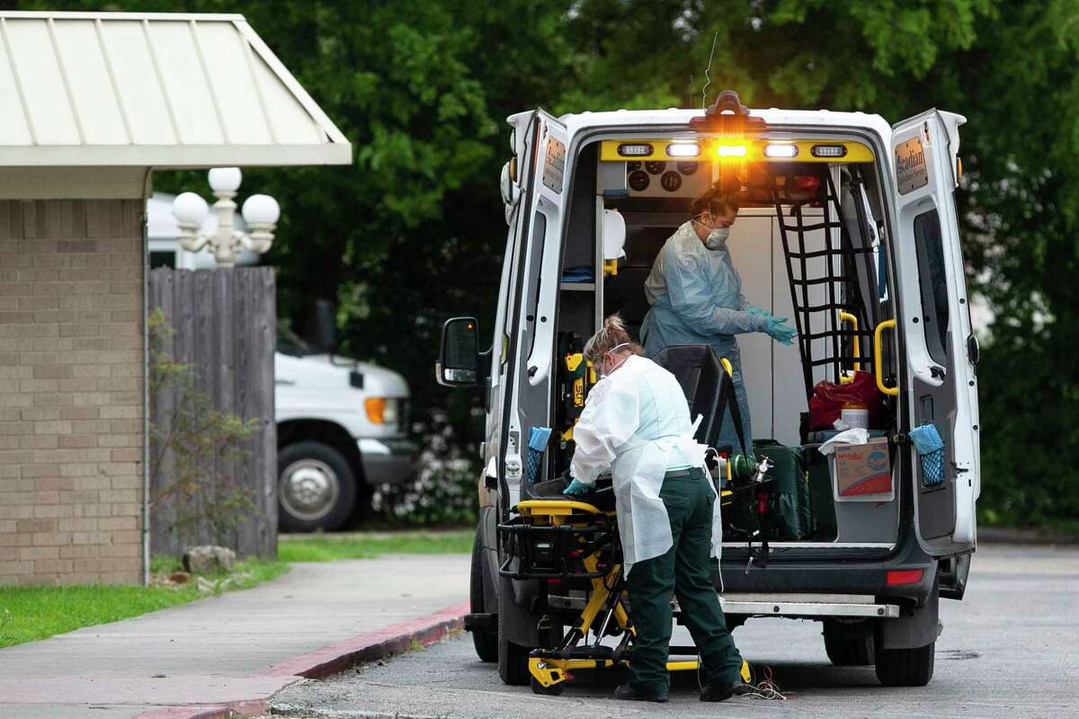 Emergency medical services personnel disinfect their vehicle and equipment after responding to a call at Southeast Nursing and Rehabilitation Center in San Antonio on April 2, 2020. An outbreak of COVID-19 has killed one resident. Another 66 of 84 residents are infected. Some employees have also tested positive.