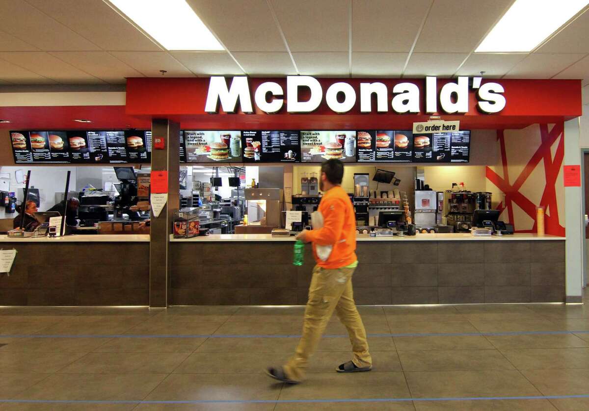 A customer walks past McDonald's at the 1-95 northbound rest plaza in Milford, Conn., on Thursday Mar. 2, 2020.
