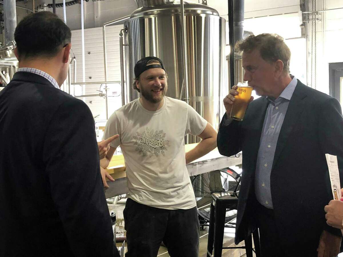 Gov. Ned Lamont samples a beer at Tribus Beer Co. in Milford Thursday Oct. 4, 2018.
