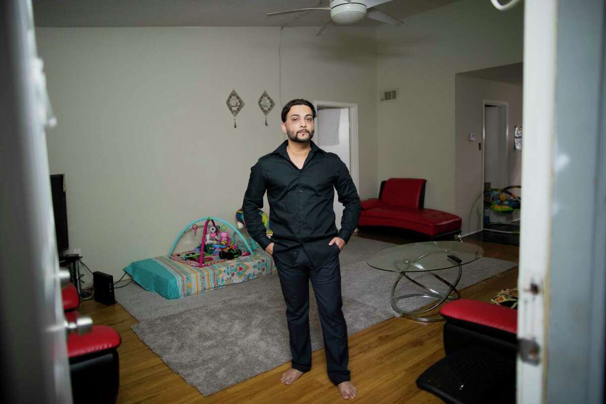After tracking the trajectory of the Covid-19 from China to western countries Muhammad Ali, a car sharing driver stop providing ride services in early March to protect his family from the virus. Ali stands on the living room of his room in Houston on Thursday, April 2, 2020.