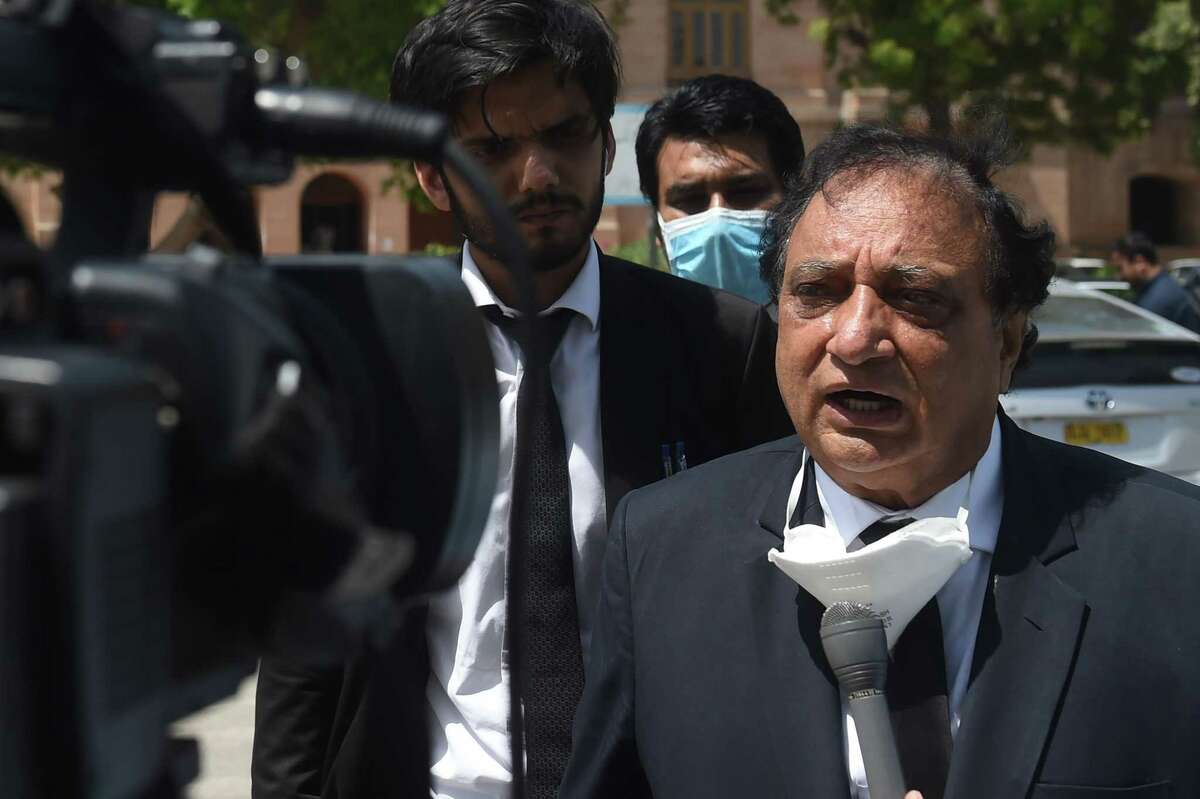Khawja Naveed (R), defence lawyer of Omar Sheikh, who was convicted to death sentence over the killing of US journalist Daniel Pearl, speaks to media representatives after a court verdict in Karachi on April 2, 2020. - A Pakistani court on April 2 overturned the death sentence for British-born militant Ahmed Omar Saeed Sheikh, who had been convicted over the 2002 killing of American journalist Daniel Pearl. (Photo by Asif HASSAN / AFP) (Photo by ASIF HASSAN/AFP via Getty Images)