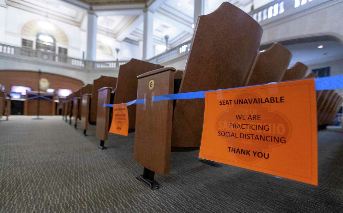 Signs indicate which seats are unavailable in the City Council chambers due to coronavirus social distancing requirements. The council heard sobering news Thursday about a projected $100 million shortfall in the city budget due to the economic fallout caused by the pandemic.