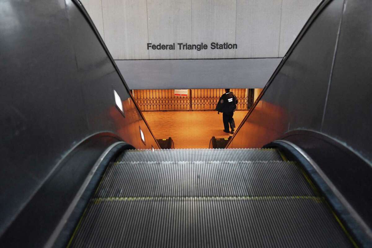 A transit officer patrols a closed Washington Metro station Thursday, April 2, 2020.