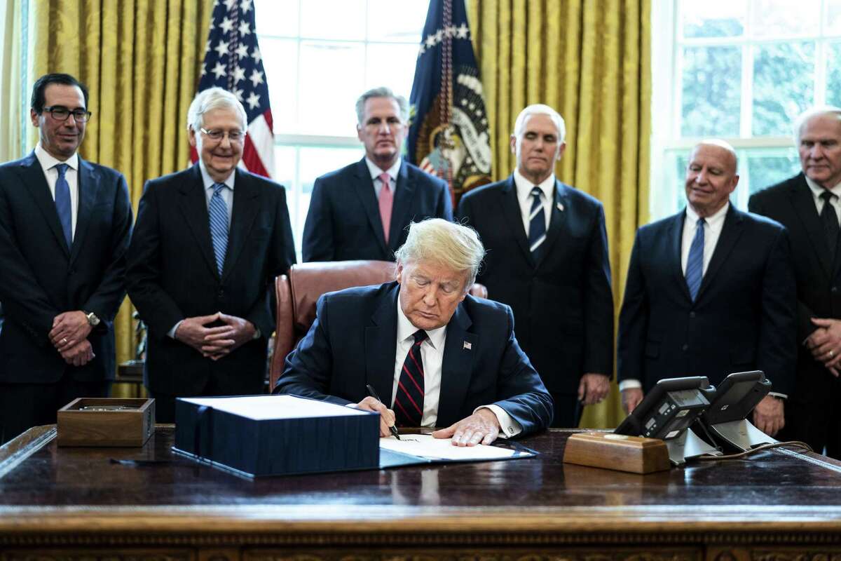 U.S. President Donald Trump signs the H.R. 748, Coronavirus Aid, Relief, and Economic Security Act, or the CARES Act, on Friday, March 27, 2020. It’s the largest stimulus package in U.S. history today, a $2 trillion bill intended to rescue the coronavirus-battered economy.