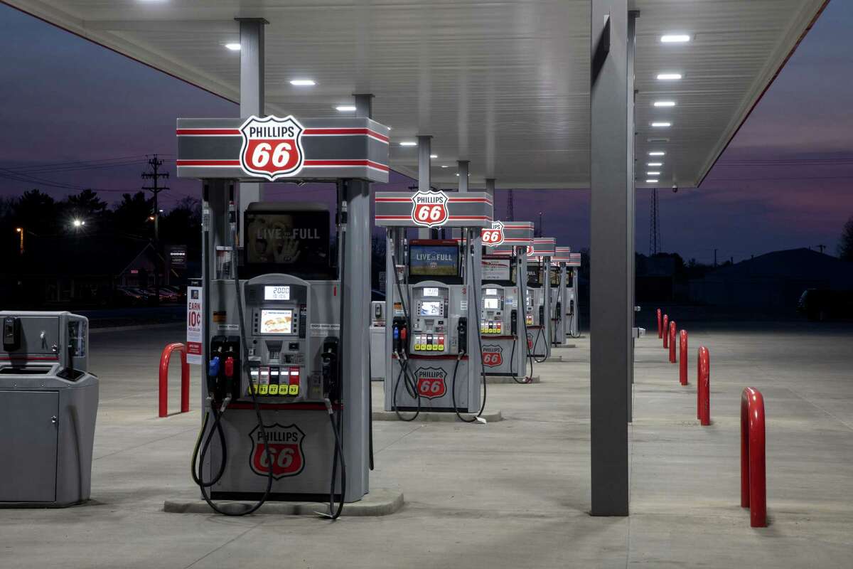 Fuel pumps stand empty at a Phillips 66 gas station. An unprecedented plunge in global energy drove the world's oil producers to strike a deal to cut output.
