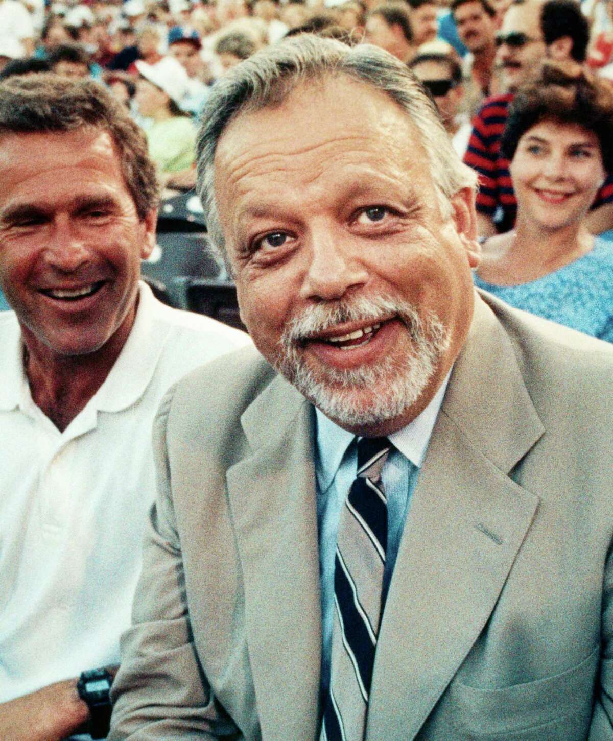 Baseball Commissioner A. Bartlett Giamatti, shown here in an August 22, 1989 file photo with Texas Rangers owner George W. Bush behind him.