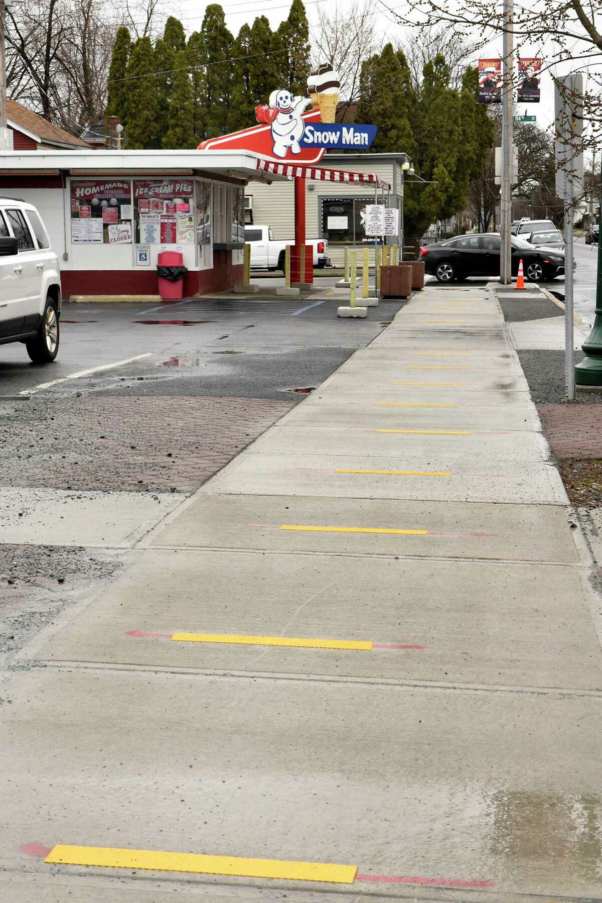 Social distancing marks are seen on the sidewalk in front of Snowman ice cream stand on Friday, April 3, 2020 in Troy, N.Y. Owner John Murphy carefully set up everything to deal with social distancing but was forced to close when people ignored the safeguards. He's allowing pre-ordered pickup and trying to figure out how to reopen. (Lori Van Buren/Times Union)