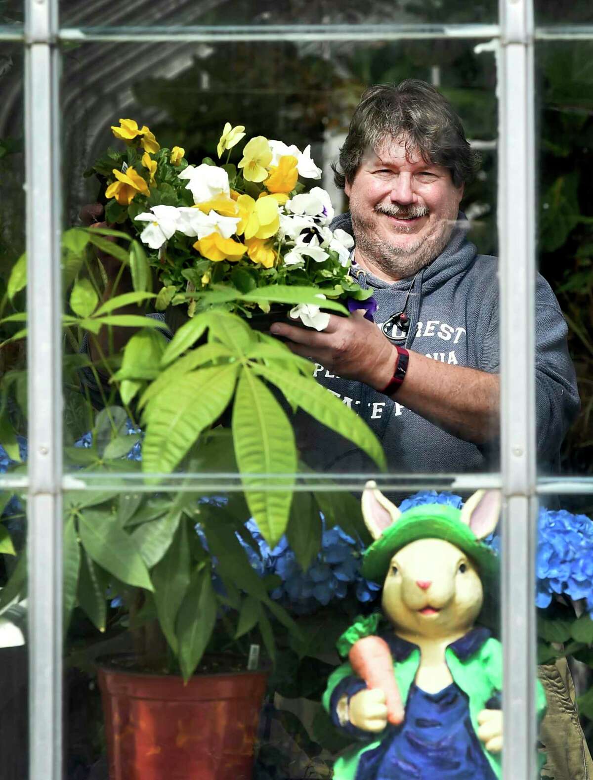 Scott Hickman, executive director of the G.R.O.W.E.R.S. program (Growing Real Opportunities With Education Relationships & Stability) at Edgerton Park in New Haven on April 2, 2020 with his plants and flowers. Despite the coronavirus, he is keeping his retail greenhouse operating on limited hours and will sell flowers and plants for Easter soon.