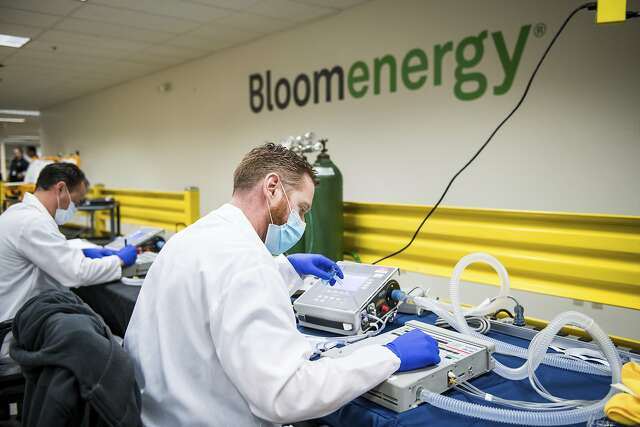 Alex Hawks, a biomedical technician with Cure Biomedical, tests ventilators at Bloom Energy in Sunnyvale in March. One question medical ethicists must face is what to do if there aren’t enough ventilators to go around, as hospitals become deluged with COVID-19 patients.