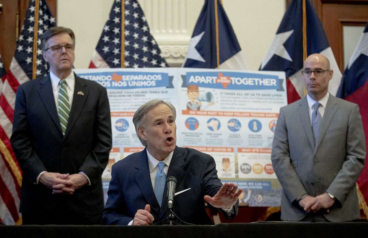 Texas Gov. Greg Abbott, flanked by Lt. Gov. Dan Patrick, left, and House Speaker Dennis Bonnen, speaks during a Capitol news conference about the state's response to the coronavirus. (Nick Wagner/Austin American-Statesman/TNS)