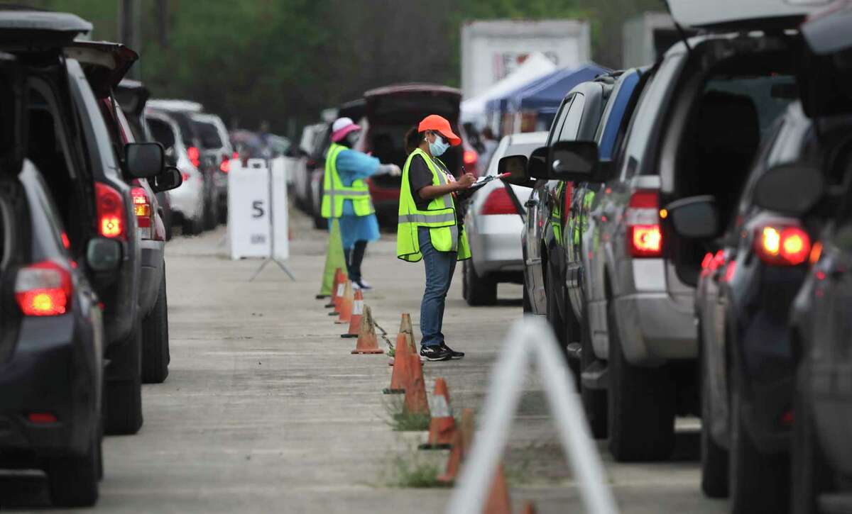 Vehicles line up to receive food items at the San Antonio Food Bank's mobile food distribution location at Brooks City Base. The first driver arrived at 4 a.m. Friday, six hours before distribution started.