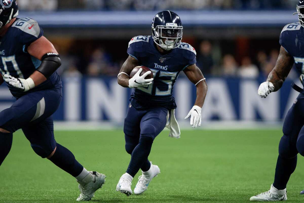 INDIANAPOLIS, IN - DECEMBER 01: Tennessee Titans running back Dion Lewis (33) runs through a hole in the line during the NFL game between the Tennessee Titans and the Indianapolis Colts on December 1, 2019 at Lucas Oil Stadium, in Indianapolis, IN. (Photo by Zach Bolinger/Icon Sportswire via Getty Images)