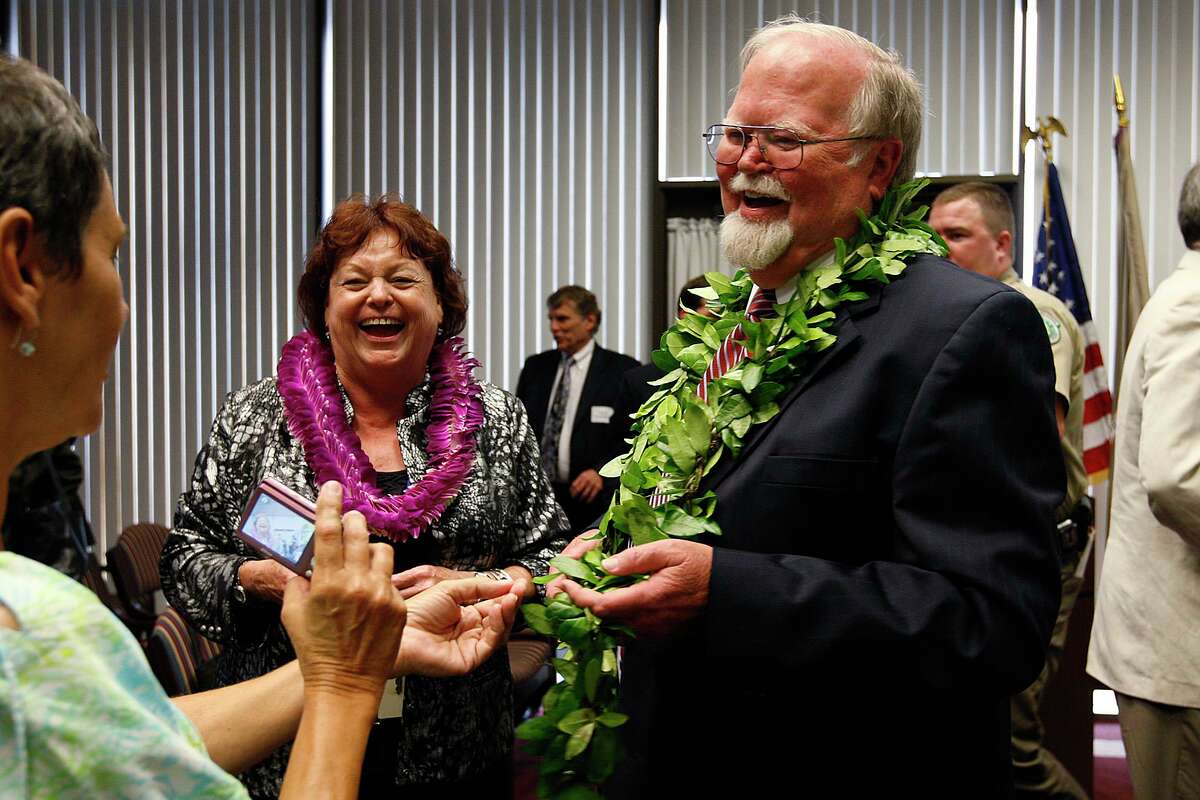 LeRoy Jahn (center) and husband Ray Jahn, right, laugh with Beverly Galarza as the U.S. Attorney couple is honored during a retirement ceremony reception at the Pyramid Building in 2010.