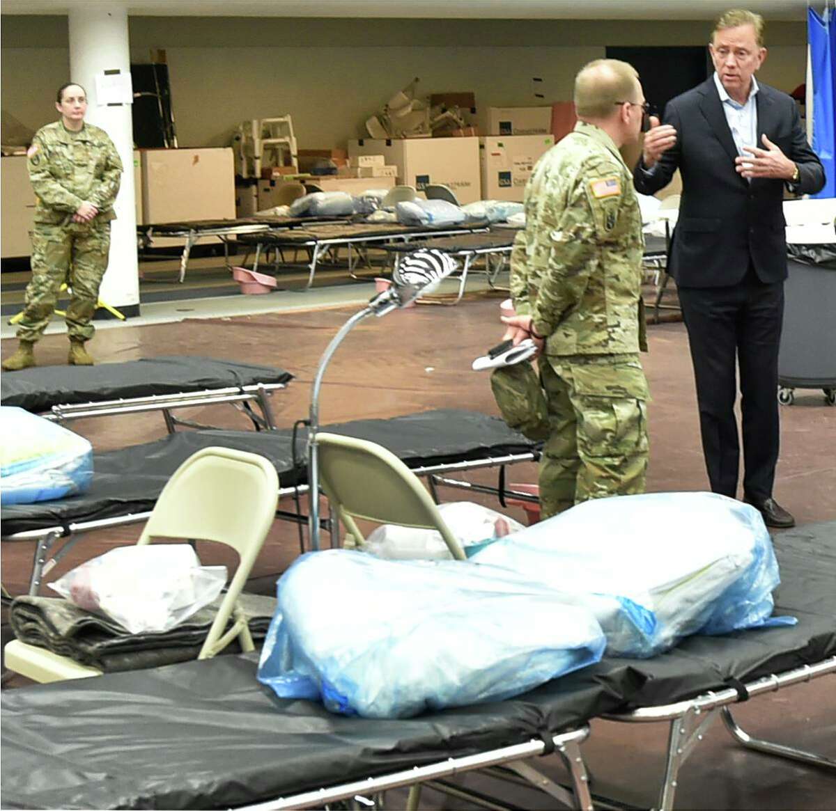 New Haven, Connecticut - Wednesday, April 01, 2020: Connecticut Governor Ned Lamont, right, speaks with U.S. Army Major General Francis Evon, the Connecticut National Guard Adjutant General as he tours a Federal Emergency Management Agency 250-bed medical field hospital Wednesday for non-coronavirus patients staged in the Southern Connecticut State University Moore Field House in New Haven by 75 members of the Connecticut National Guard's 1-102nd Infantry. The site is intended to treat non-COVID-19 patients so there will be more hospital beds people who are impacted by COVID-19 / Coronavirus.