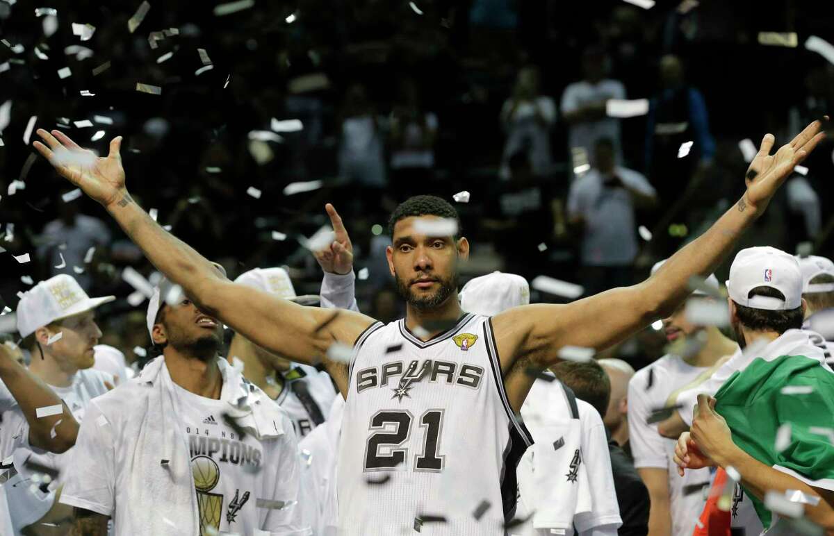 Tim Duncan is one of the top 10 players in NBA history, according to ESPN experts. The photo shows Duncan celebrating one of five NBA championships with the Spurs.