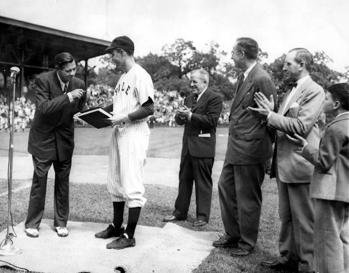 Baseball legend Babe Ruth presents his papers to Yale University in 1948. They are received by Yale baseball team captain, George Bush. Also present are: Bob Kiplurth, Yale Athletic Director; Professor James T. Babb, Yale University Librarian for Preservation; and Mayor Celentano and his son.