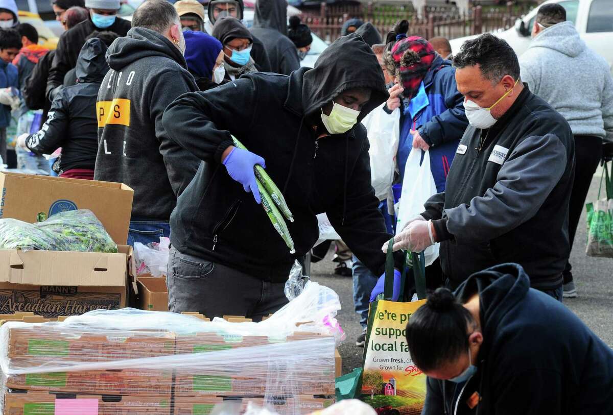 PT Partners hold its monthly PT Barnum food distribution event in Bridgeport, Conn., on Saturday Apr. 4, 2020. The coronavirus has increased demand for food and PT Partners say they are now running low on donations from various food banks they rely on.