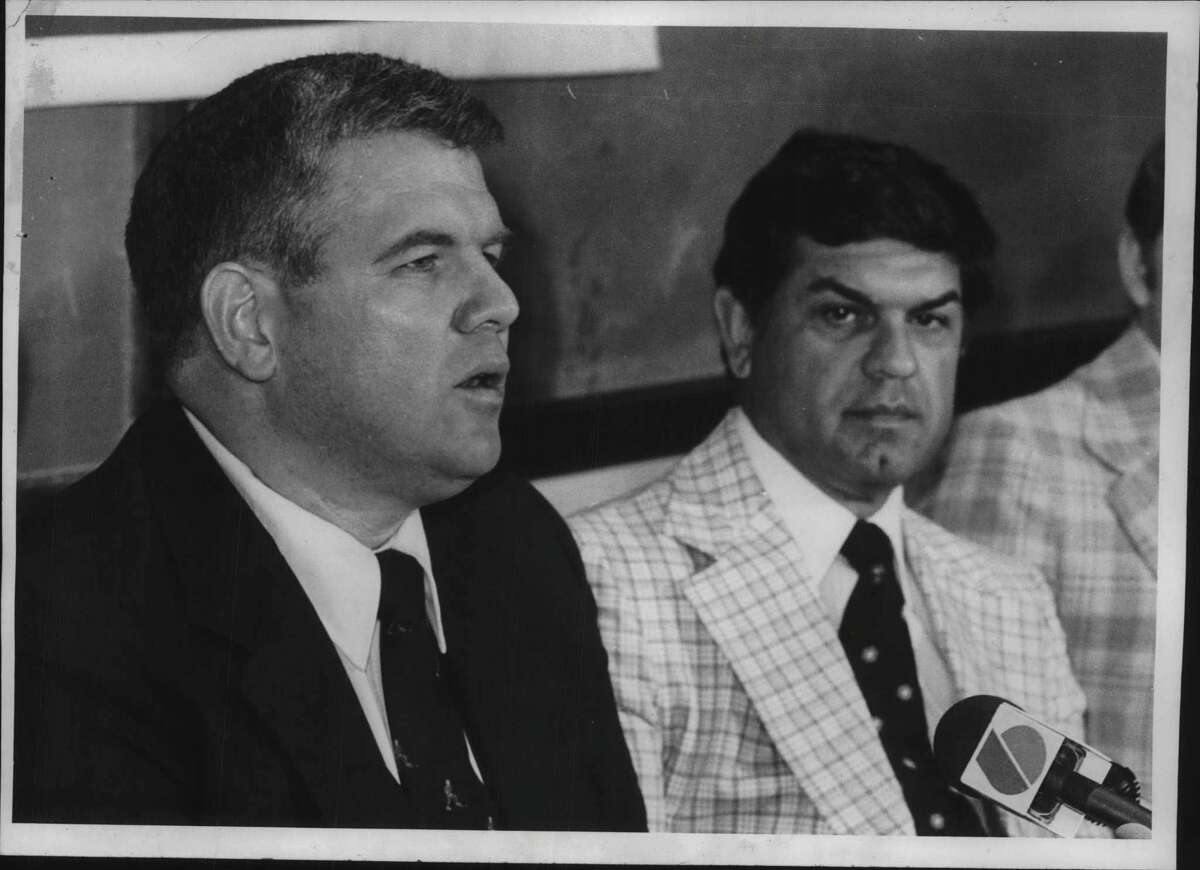 Mike Addesa, new head hockey coach at RPI, speaks to media as Robert F Ducatte, athletic director at RPI College in New York, looks on. Undated (Bud Hewig/Times Union Archive)