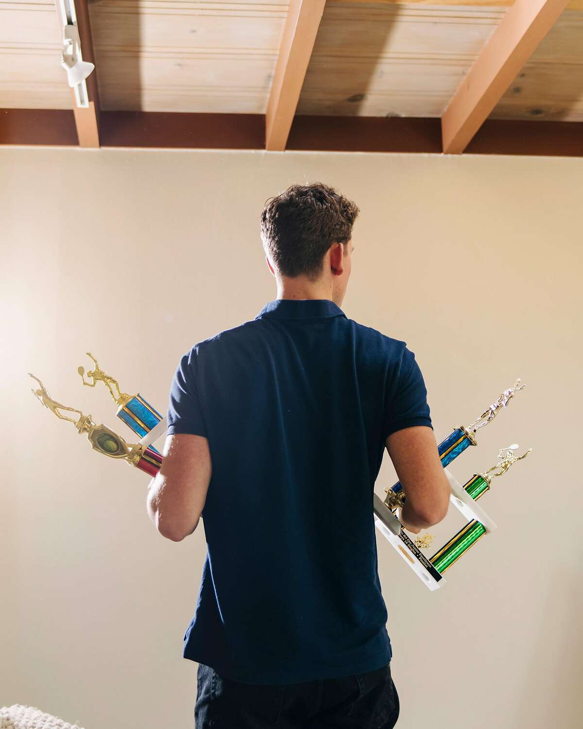 Stevie Gould and his tennis trophies in Marin County, Calif., Feb. 15, 2020. The United States Tennis Association has asserted it can police itself when it comes to abuse cases, but the story of one coach in California raises doubts. (Cayce Clifford/The New York Times)