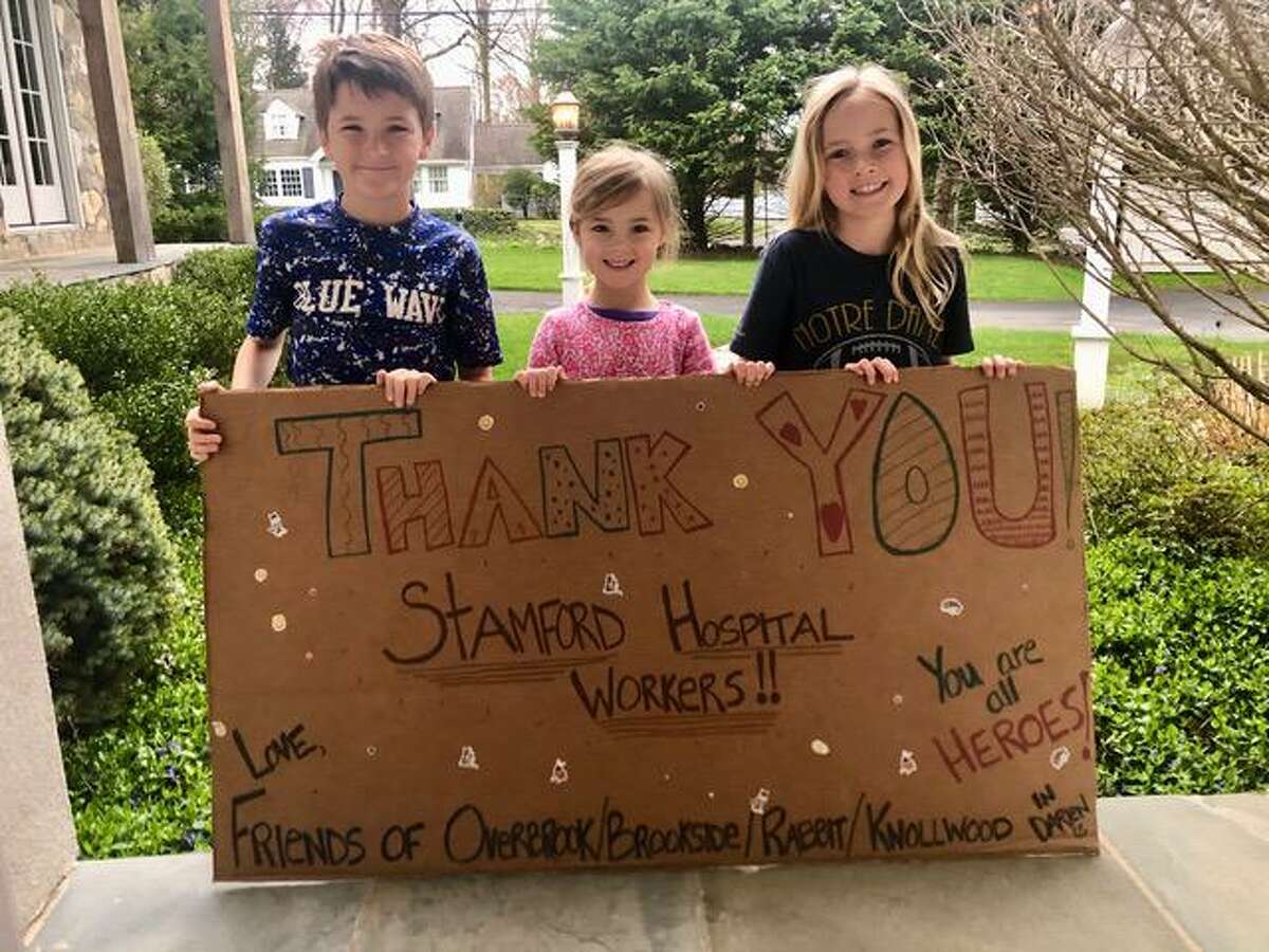 Jack, Brynn and Maddie Mitchell made this poster and the hospital hung it in their halls Saturday to lift everyone’s spirits.