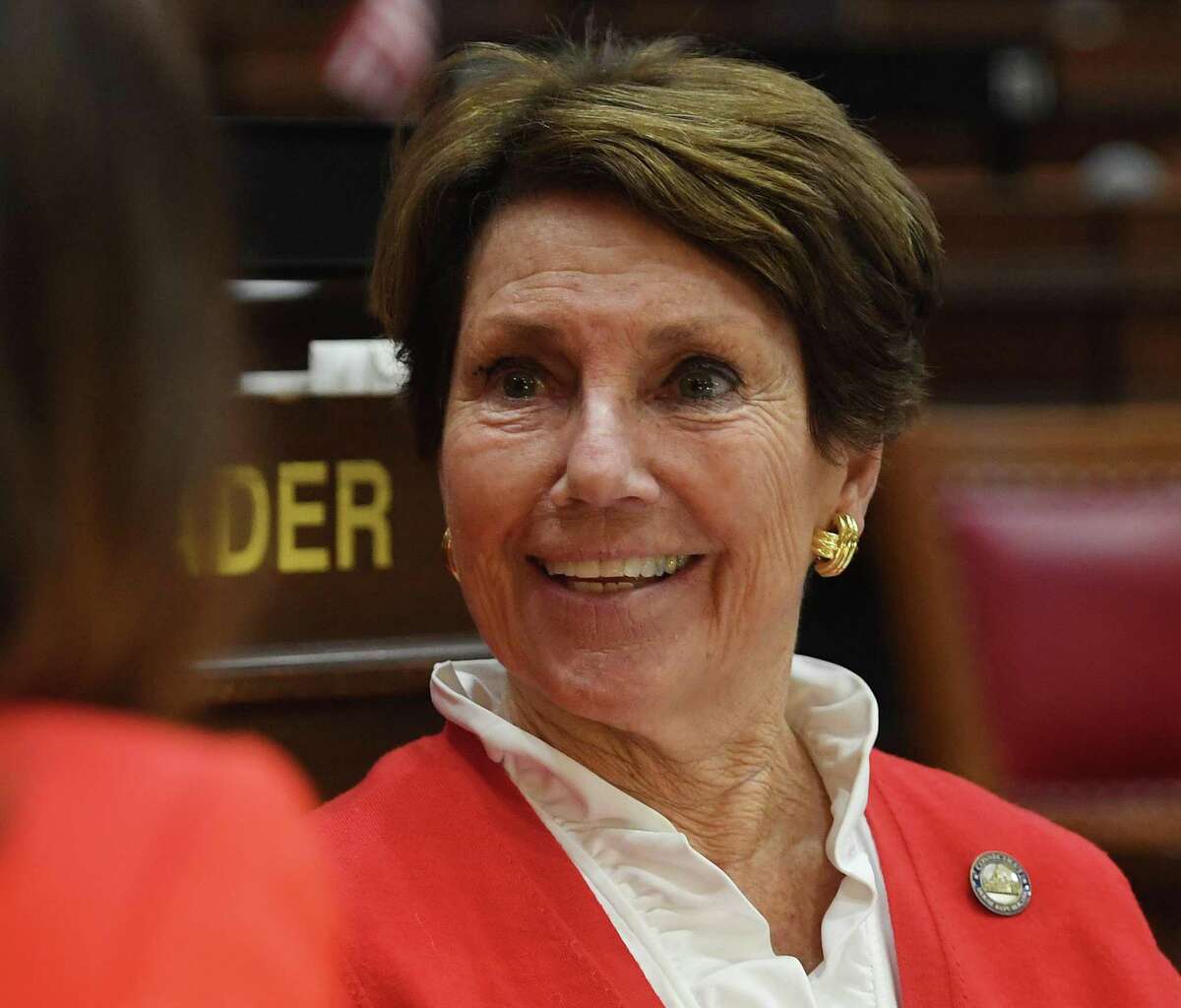 Rep. Livvy Floren, R-Greenwich, chats with a fellow legislator during opening session of the state legislature in Hartford, Conn. on Wednesday, February 05, 2020.