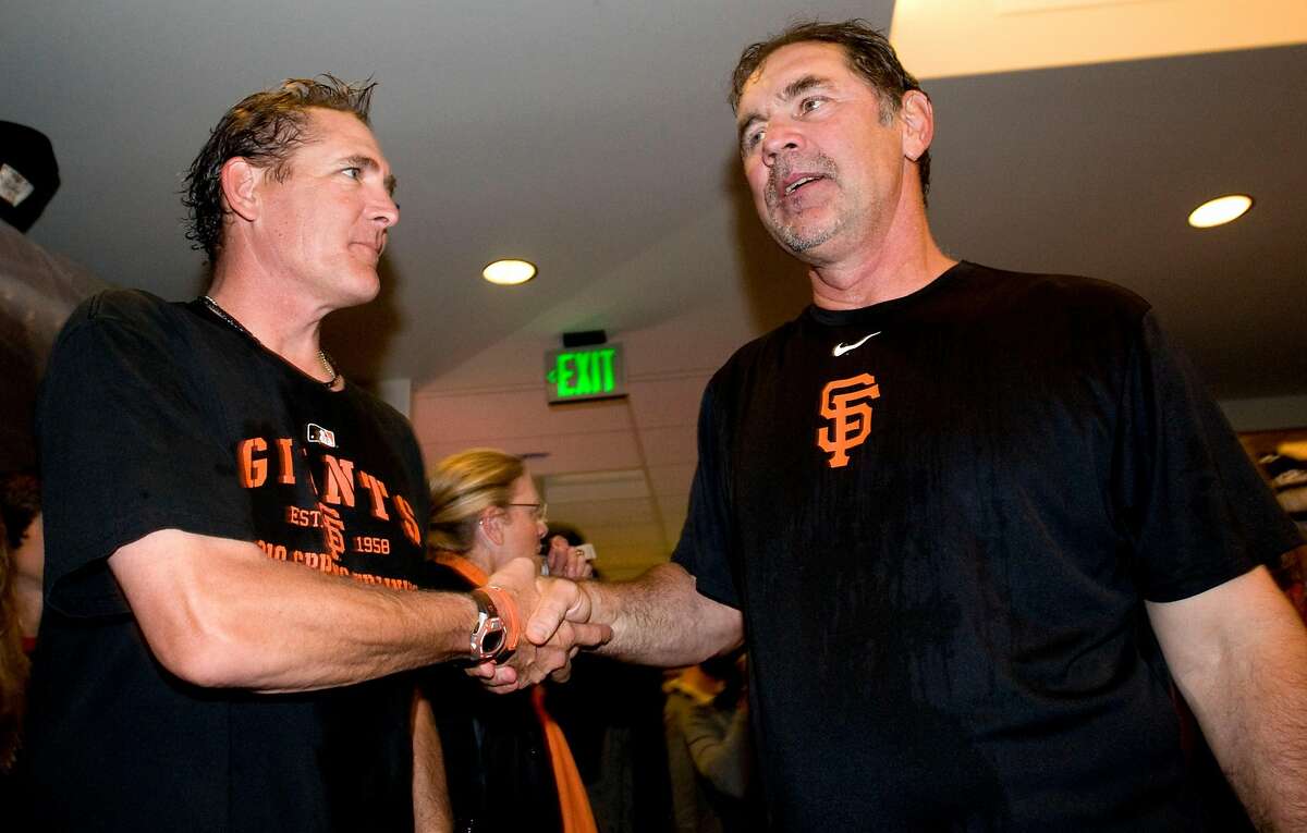 Dave Righetti (left) shakes the hand of Bruce Bochy as the San Francisco Giants celebrate their National League West Championship after defeating the San Diego Padres at AT&T Park on Sunday.