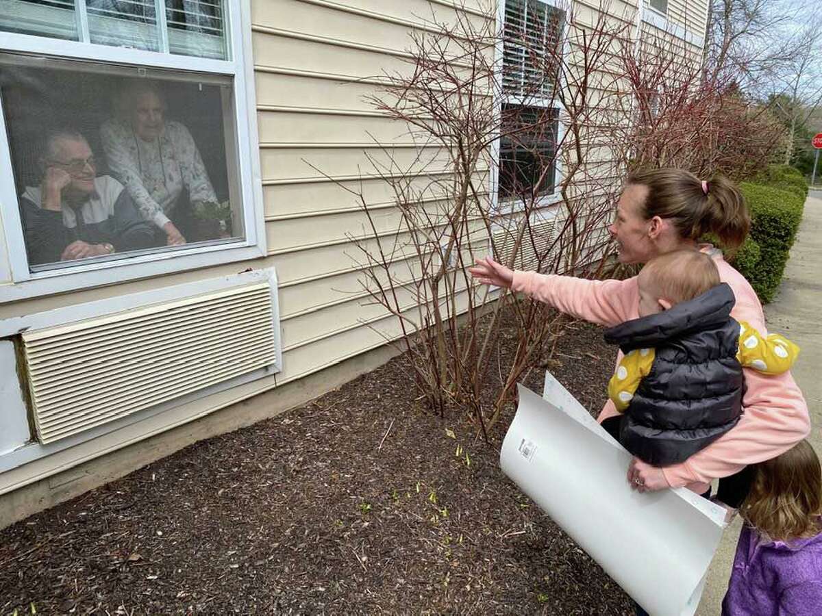 Spring Meadows Trumbull, is utilizing Skype or FaceTime to communicate with loved ones during this difficult time. They even have some family members visiting the old fashioned way. Pictured is Kristin Kelly surprising her grandparents, Jack and Mary Kelly with a visit, sending love and encouragement