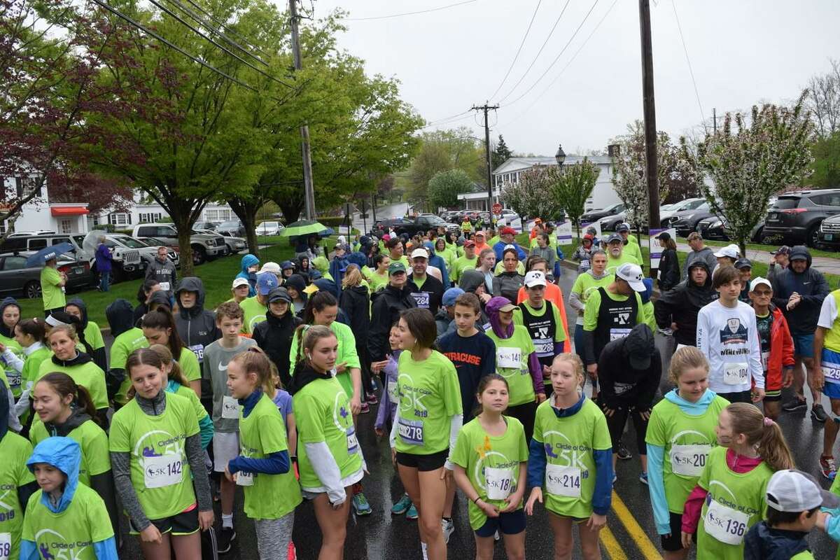 Hundreds line up in the rain for the start of the 2019 Circle of Care 5K/Run Walk to support families whose children have cancer. This year’s race is going virtual.