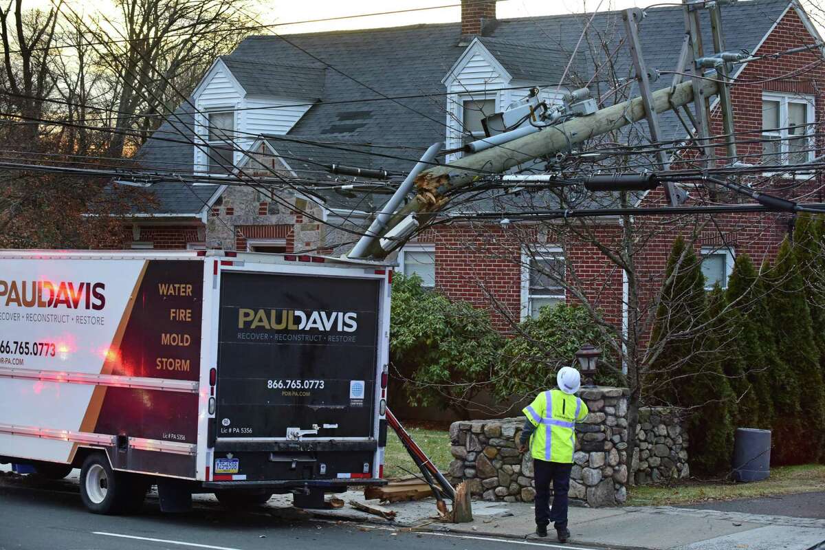 An Eversource Energy worker at the scene of a Norwalk, Conn. accident in January 2020, after a box truck struck a utility pole.