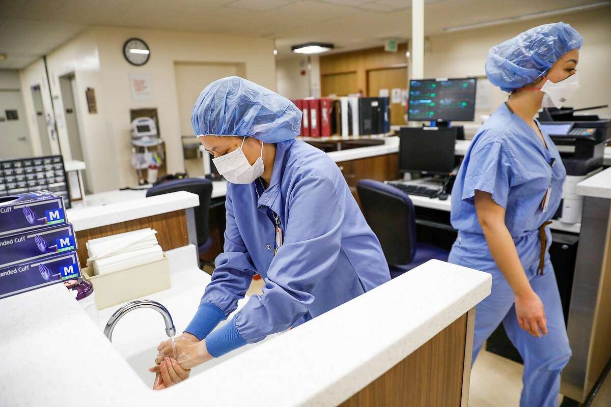 Supervising nurse Regina Truong (left) washes her hands as she works on the Covid-19 floor at Saint Francis Hospital in San Francisco on Monday, April 6, 2020.