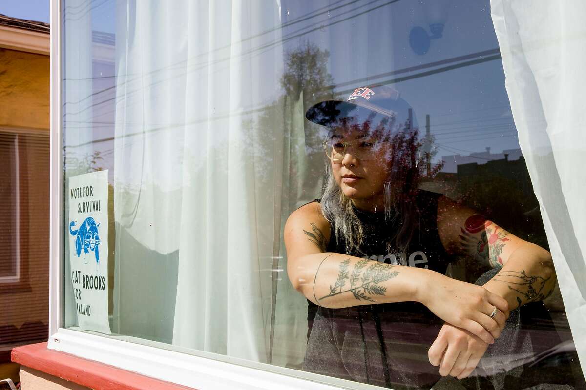 Olivia Lee of the band Theres Talk poses for a portrait in the window of her home in San Francisco, Calif. Tuesday, March 31, 2020. ÒI have been moving through such deep, visceral waves of grief with this whole thing. But itÕs firing up our activist spirits and weÕre all digging down into what we can all offer each other, our marginalized communities, and folx hurting & really at a loss right now,Ó says Lee. ÒI live in a queer organizer and musician house and community care is part of our ecosystem. We all kicked into gear immediately. I started raising & dispersing funds for queer musicians, and my roommates started a livestream show to showcase & support artists. We joked about it, but we are applying polyamory negotiation principals to our house meetings. And weÔre dividing tasks up and creating a sort of emotional equilibrium of care when things are too much for one of us to handle. And there is also huge lightness stillÑ singing over soup in the kitchen, lending butter so baked goods can be made and delivered, everyone on calls in separate rooms. There is such a bustling, bursting joy and aliveness.Ó