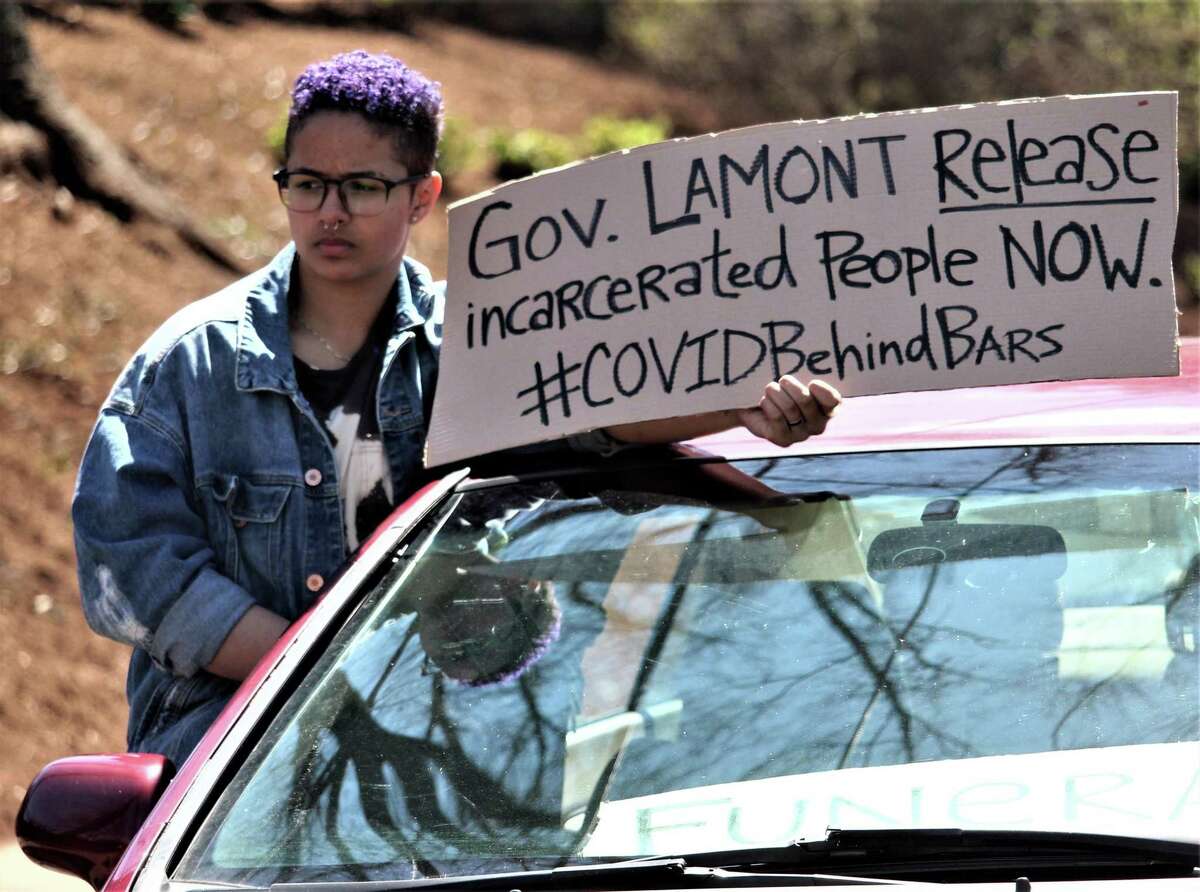 More than 50 cars gathered in front of the governor's Executive Residence in Hartford last month, as protesters for prison release in the coronavirus crisis remained in their cars and honked, stopping traffic for about an hour. Pictured is Eliza Brown of New London, an advocate.