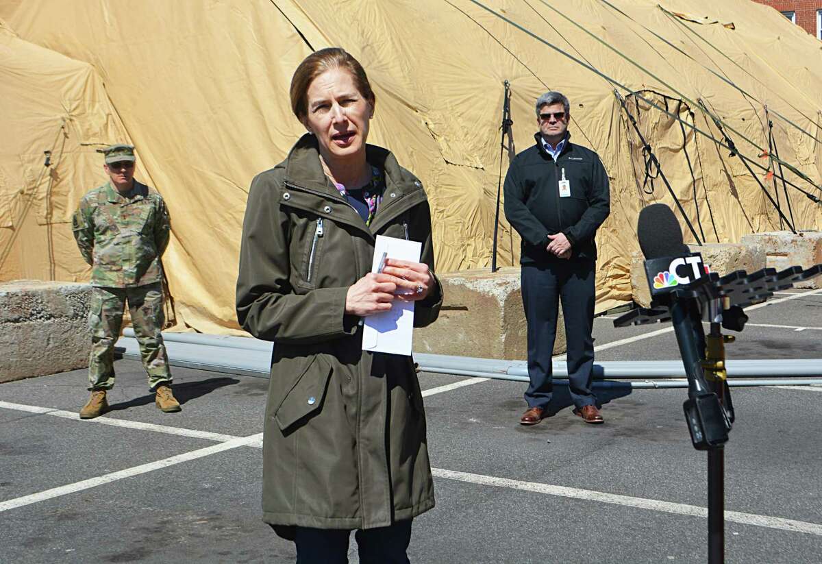 Lt Gov. Susan Bysiewicz and Maj. Gen. Francis J. Evon Jr., adjutant general of the Connecticut National Guard, speak to reporters about the 25-bed mobile unit at Middlesex Hospital in Middletown Monday afternoon.