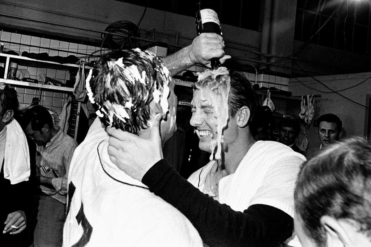 In this Sept. 17, 1968, file photo, Detroit Tigers pitcher Denny McLain, his head covered in shaving cream, pours a bottle of champagne over the head of teammate Al Kaline as they celebrate their American League pennant victory in the dressing room in Detroit. (AP Photo/File)