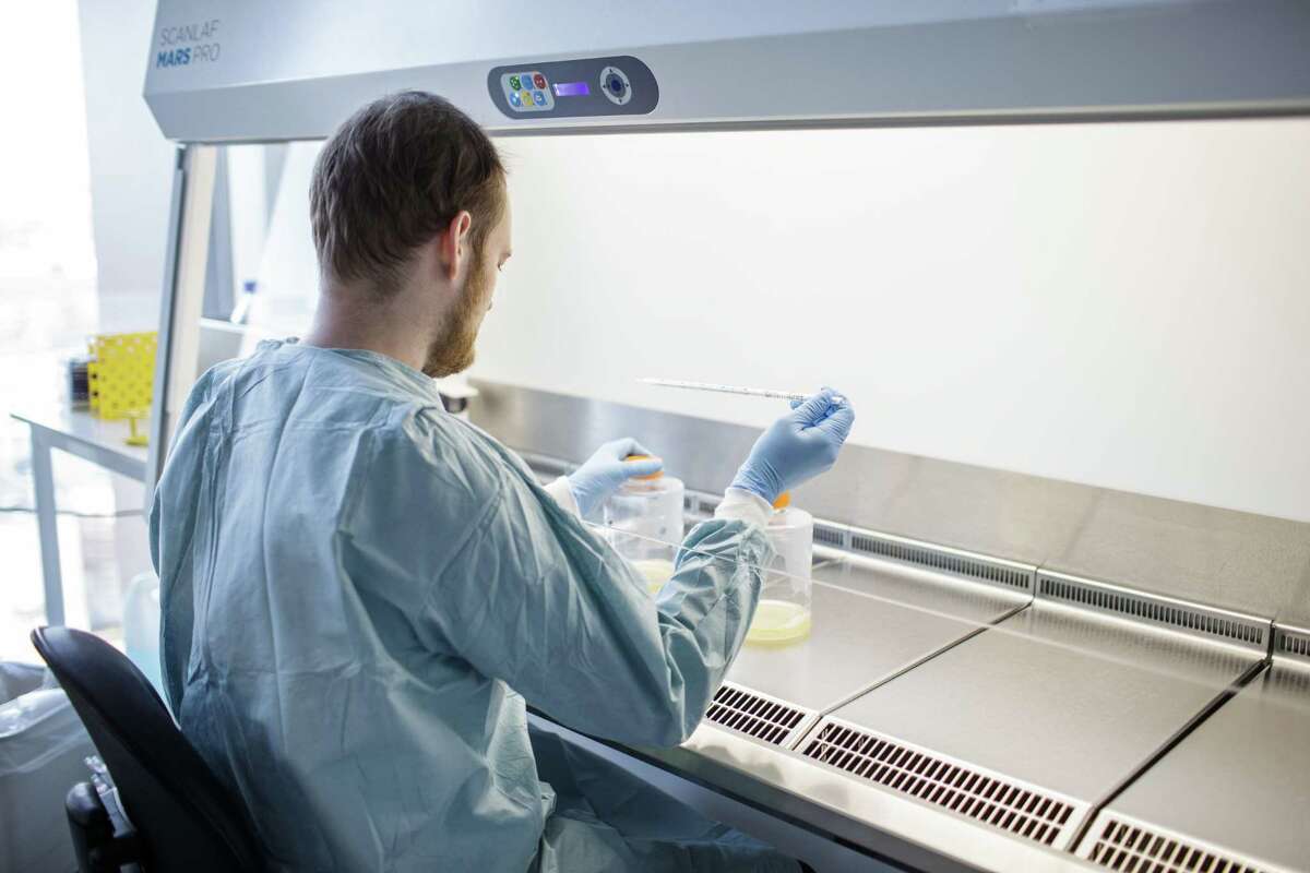 A Copenhagen University researcher works on a potential coronavirus vaccine in March 2020. On April 6, Danbury-based Iqvia Holdings announced an online tool to match patients afflicted with the virus with clinical research and trials under way.