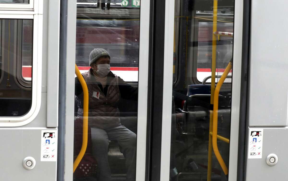 A passenger wears a protective mask while riding a San Francisco MUNI bus during the coronavirus (COVID-19) pandemic on April 06, 2020 in San Francisco, Calif.