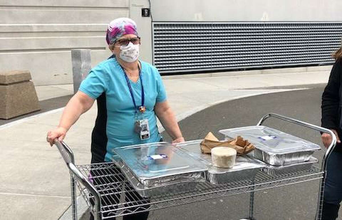An emergency room nurse at Danbury Hospital accepts lunch for herself and her colleagues donated by the Wilton Warriors’ Front Line Appreciation Facebook group.