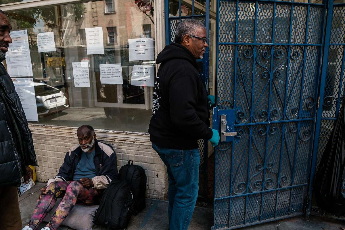 Joe Wilson, the executive director of Hospitality House, a men's homeless shelter in the Tenderloin enters the shelter in San Francisco, Calif. on Tuesday April 7, 2020.