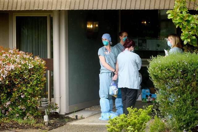 A nurse from John Muir Medical Center prepares to enter Orinda Care Center on Monday.