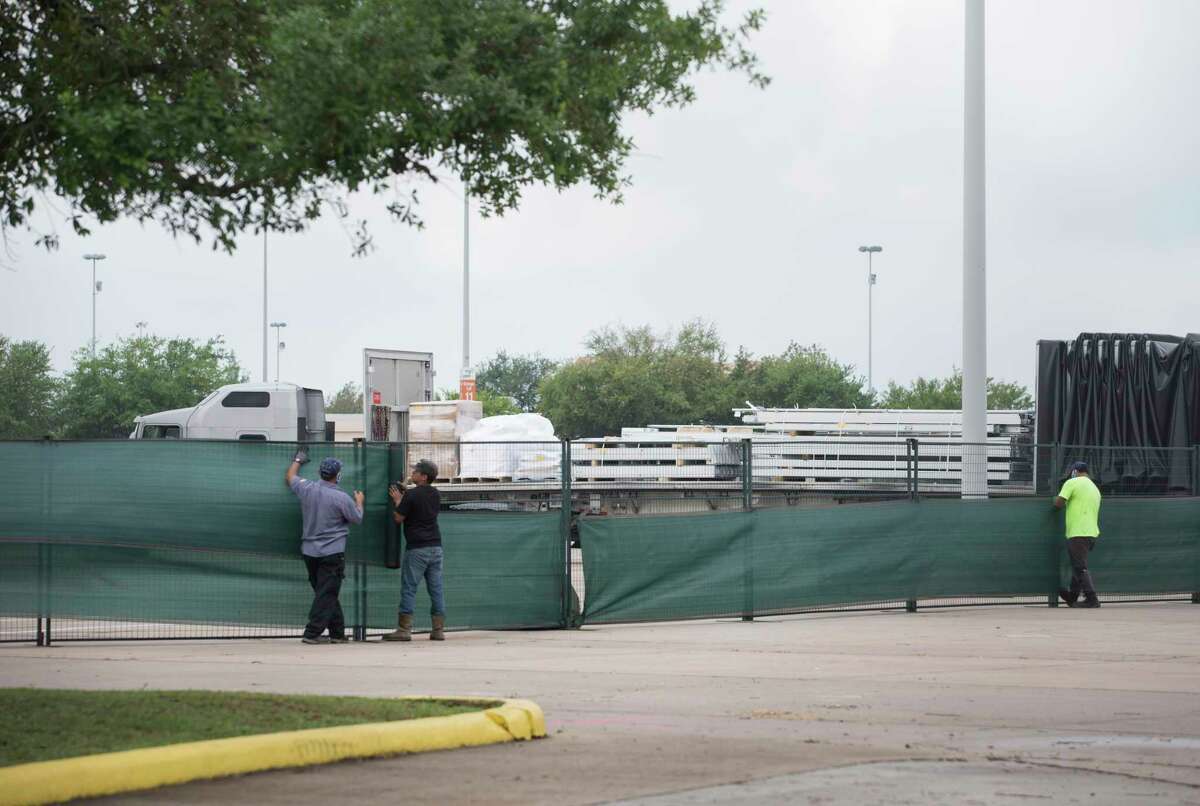 Workers set up a makeshift field hospital at NRG Park in preparation for an expected surge of COVID-19 patients in Harris County Tuesday, April 7, 2020, at Orange Lot in Houston.