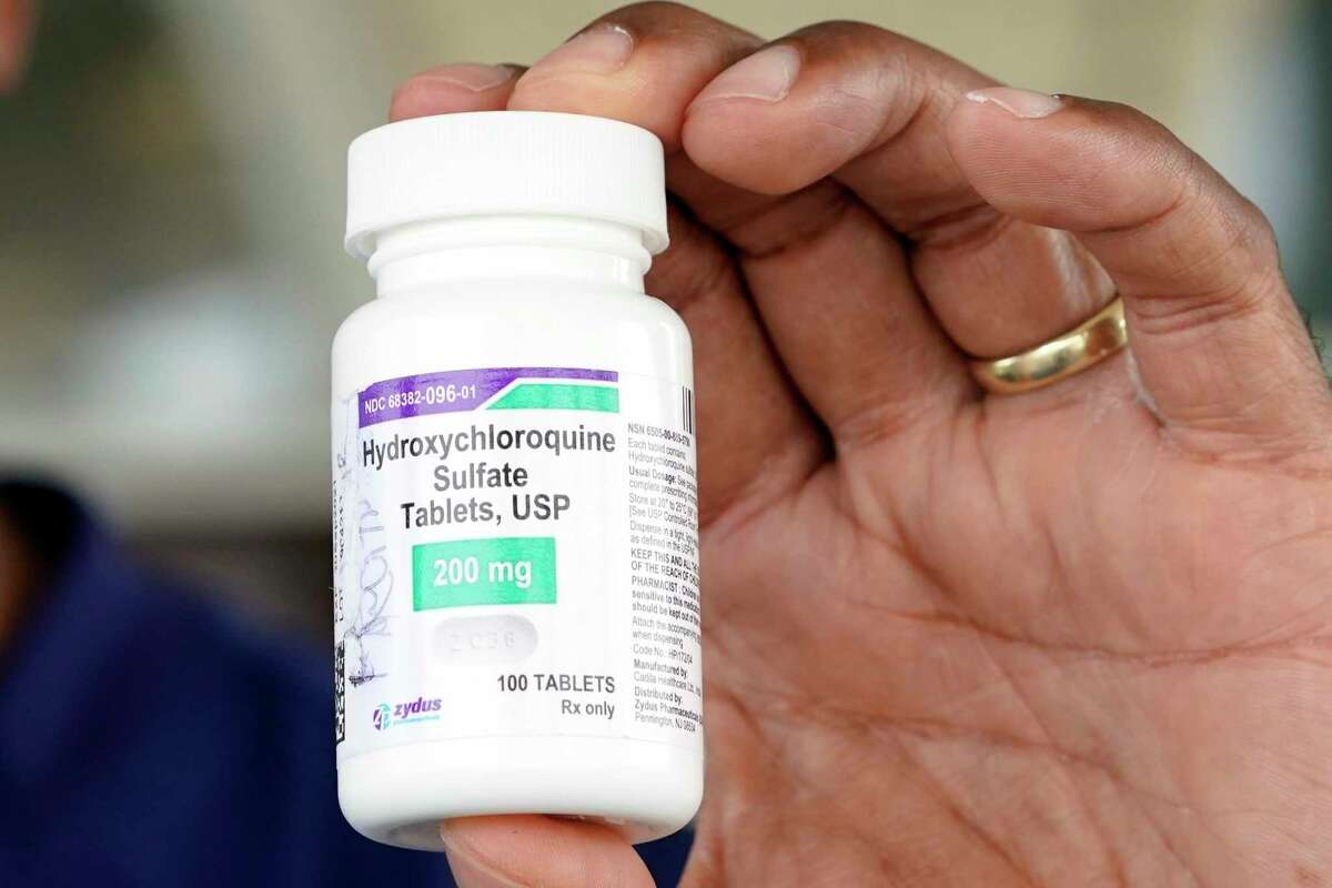 Dr. Robin Armstrong holds a bottle of hydroxychloroquine while posing outside The Resort at Texas City nursing home, where he is the medical director, Tuesday, April 7, 2020, in Texas City, Texas.