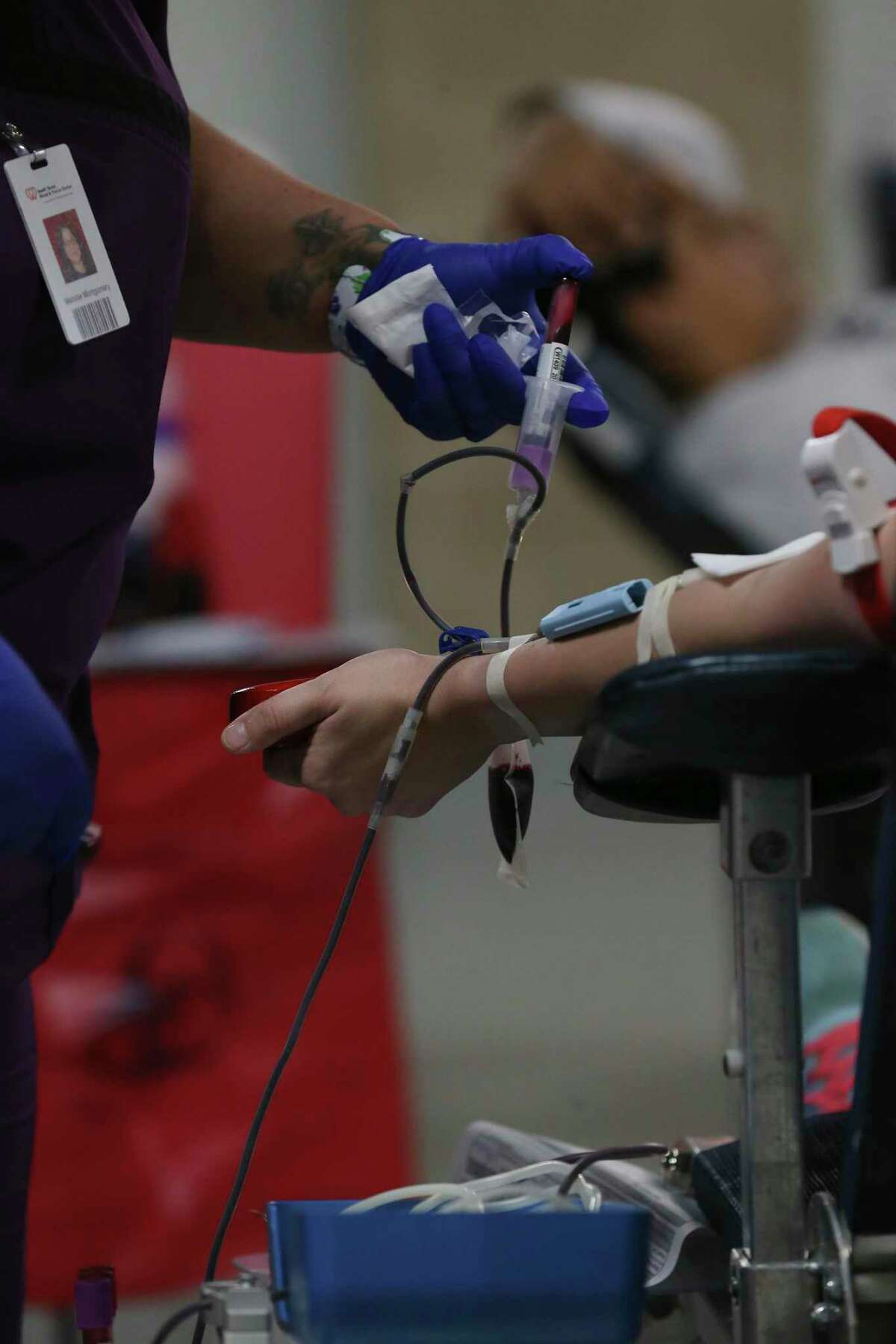 People donate blood at the Alamodome during a 3-day blood drive on March 17, 2020.