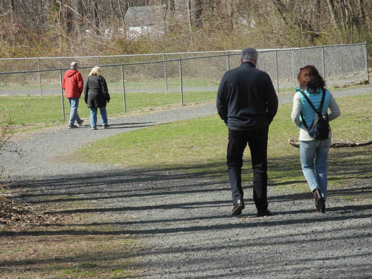 Couples allow considerable space between themselves while walking in Merwin Meadows in Wilton during a previous year. Residents of the town recently joined their neighbors over the Memorial Day Weekend 2021, for an open house, along with fun events that were free.