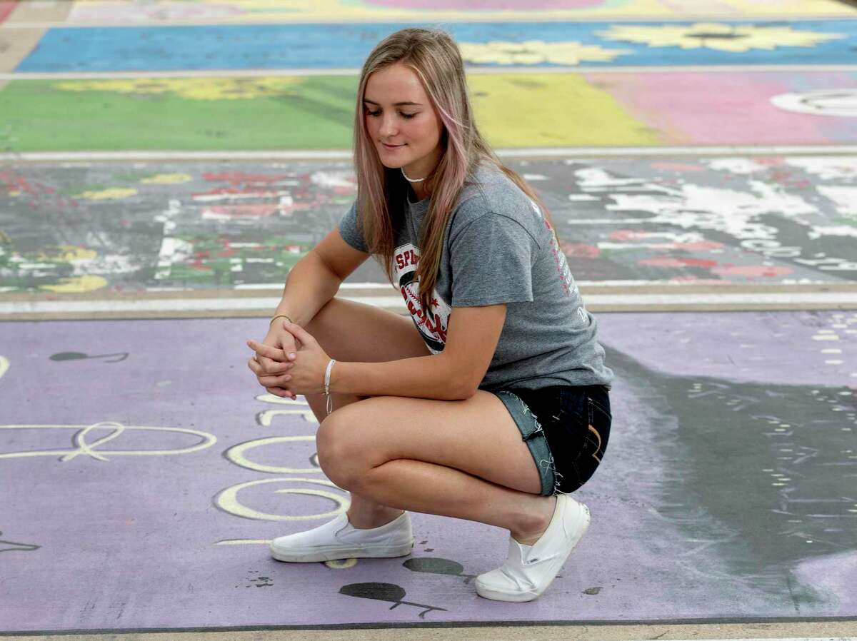 Shaelyn Sanders poses for a portrait at her painted parking spot at Splendora High School, Thursday, March 26, 2020, in Splendora. "The COVID-19 pandemic has definitely turned my senior year around, I went from counting down the days till graduation to hoping I would even get one. It has all happened so fast; this virus may be taking away a few of the memories I’ve been looking forward to since I was a little girl. I may not get my last year of high school softball, prom, or a graduation. I wish this would have never happened, but I am trying to be positive and make the best out of the time off."