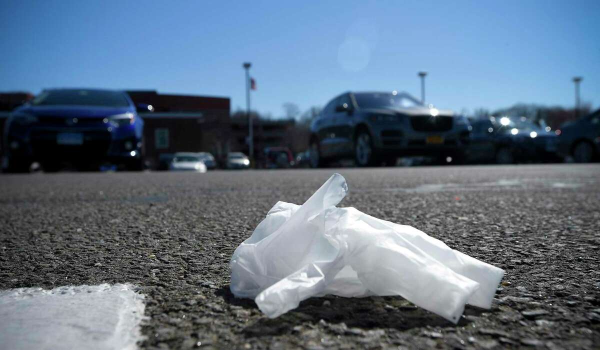 Discarded plastic rubber gloves are photographed on March 27, 2020 in a parking lot of a local shopping market in Stamford.
