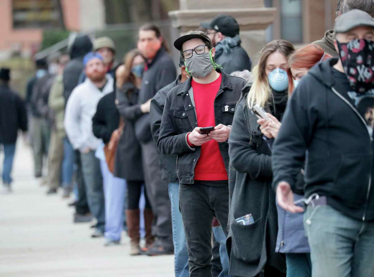 People line up to vote in Milwaukee Tuesday. This isn’t sustainable in a pandemic, but the nation also isn’t prepared to switch to voting by mail.