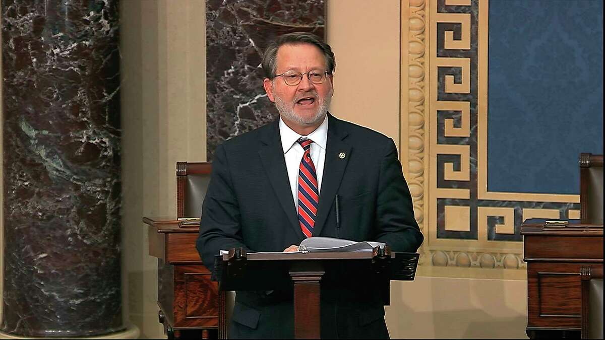 Sen. Gary Peters, D-Mich., seen speaking on the Senate floor March 25, has proposed a $13 per hour increase for essential workers on the front lines of the coronavirus. (Senate Television via AP)